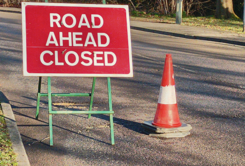 Image of Road Closed Ahead sign, with traffic cone