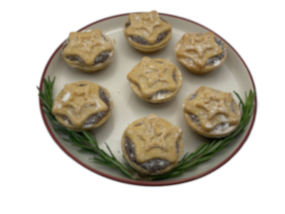 Photo of mince pies on plate with green plant